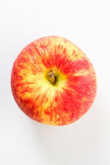 Closeup of ripe organic red apple on white table background. Selective focus.