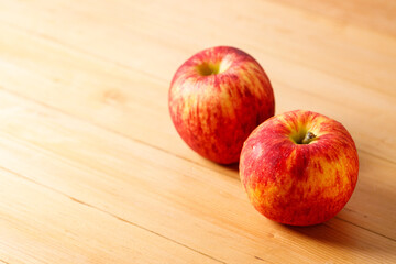 Ripe organic red apple on wooden table background.