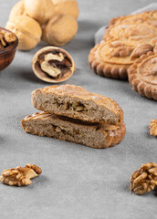 Sliced gingerbread with nut filling on a gray background. Homemade baking concept.