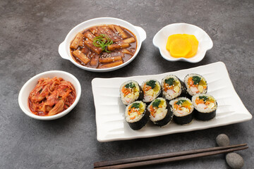 Assortment of Korean traditional dishes. Gimbap, tteokbokki, danmuji, kimchi
