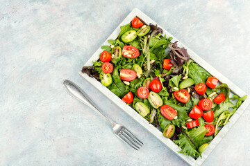 Fresh lettuce leaves and tomato salad.