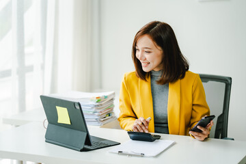 Brightly smiling businesswoman working on tablet at office Female employees check business...