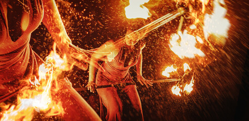 An enchanting fire dancer beautifully showcases her talent with mesmerizing flames during a performance.