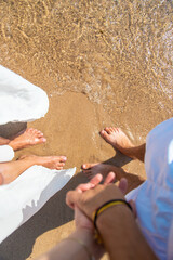 Woman and man holding hands on the seashore. Selective focus.