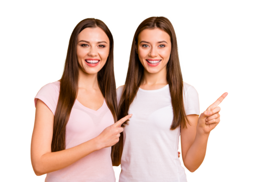 Close up photo two people beautiful she her ladies models best buddies hand arm fingers indicate direct empty space hug cuddle embrace wear white pink casual t-shirts isolated yellow background