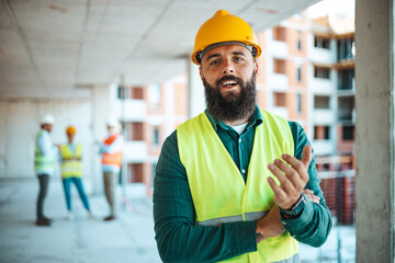 Confident Construction Worker at Building Site With Team