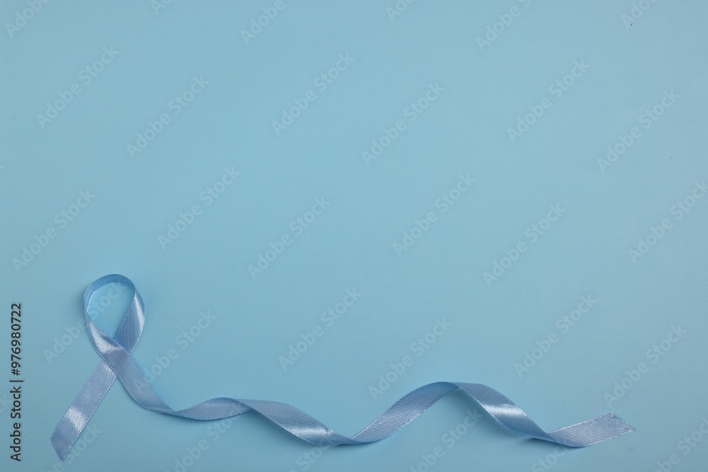 Poster Light blue ribbon on color background, top view with space for text. Prostate cancer awareness