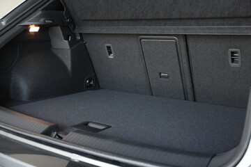 Grey soft car boot liner mat in trunk of auto