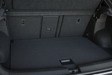 Grey soft car boot liner mat in trunk of auto