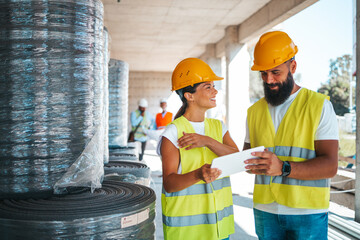 Construction Workers Discuss Plans at Building Site