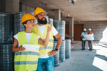 Construction Team Discussing Project at Building Site