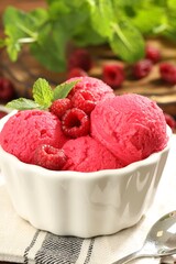 Delicious raspberry sorbet, fresh berries and mint in bowl on table, closeup