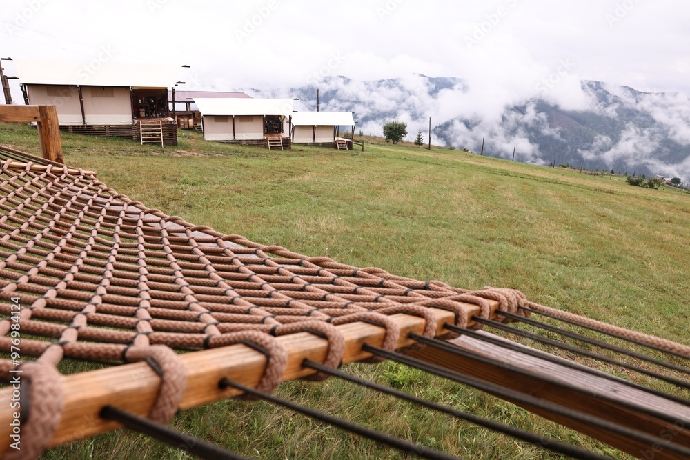 Poster comfortable net hammock in glamping site, closeup