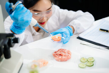 Fototapeta premium Two Asian scientists in a lab conducting food research using a microscope and lab equipment, showcasing innovation in food science