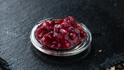 Sweet cherry and apple jam in a small bowl.