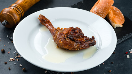 Fried duck leg confit with sauce.