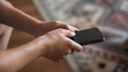 Young boy playing with a mobile phone in his hand