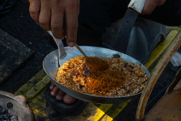 Kerak telor, a traditional street food from Jakarta, Indonesia. This food is an omelet with rice, served with fried grated coconut. Sold on a street stall