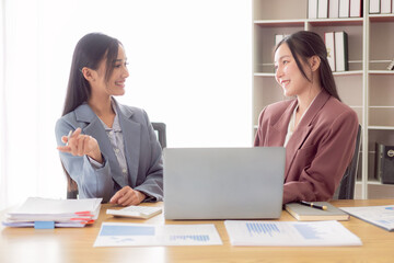 Obraz premium Two professional business women analyzing accounts planning financial report, business plan, investment, financial analysis in office.