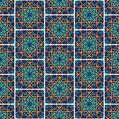 A colorful geometric pattern featuring floral designs in vibrant turquoise, orange, and blue, suitable for textile or wallpaper.