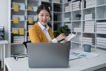 woman meticulously plans a finance audit, using a computer and calculator to review budget...