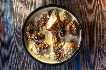 Traditional Georgian food, meat in pot on table top.