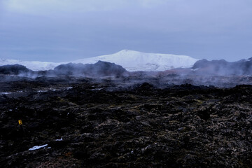 Leirhnjúkur volcanic park, with snow-capped mountains on volcanic rock and lava in autumn Iceland