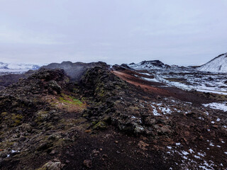 Leirhnjúkur Volcanic Park, steam rising from the snowy ground in autumn in Iceland
