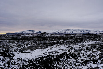Leirhnjúkur volcanic park, with snow-capped mountains on volcanic rock and lava in autumn Iceland