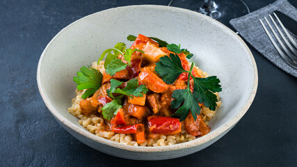 Italian vegetarian risotto with pumpkin, tomatoes, peppers and parsley.