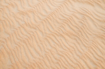 Sand with natural pattern. Beach sand background with natural wave pattern