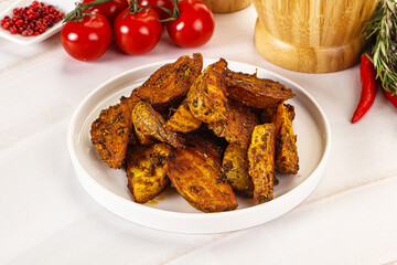 Golden baked potato Idaho with spices