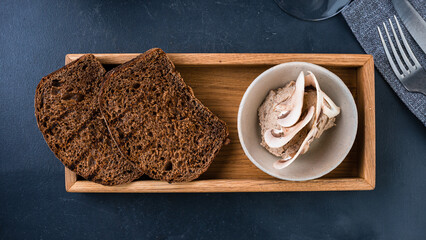 Mushroom pate from champignons with pieces of black bread.