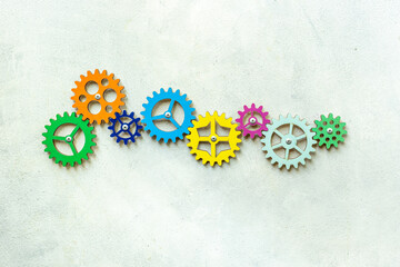 Colorful gears are connected together as a symbol of teamwork and business automation