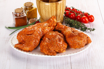Raw turkey shoulder wing in Indian tandoori marinade