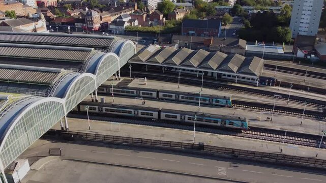 Drone. UK northern train service. Train on tracks.