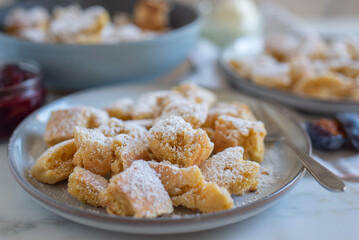 Austrian cuisine. Torn pancake (or omelet) kaiserschmarrn with honey, powdered sugar