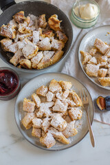 Austrian cuisine. Torn pancake (or omelet) kaiserschmarrn with honey, powdered sugar