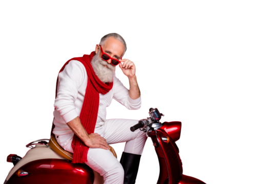 Flirty grandfather santa man sitting on retro moped wear jumper and trousers isolated red background