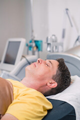 Fototapeta premium caucasian man sleep waiting surgery procedure on bed. handsome patient want skin young and smooth rest preparing for operation on medical bed. white man lying on bed sleep waiting facial treatment