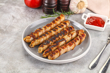 Grilled meat sausages wrapped bacon