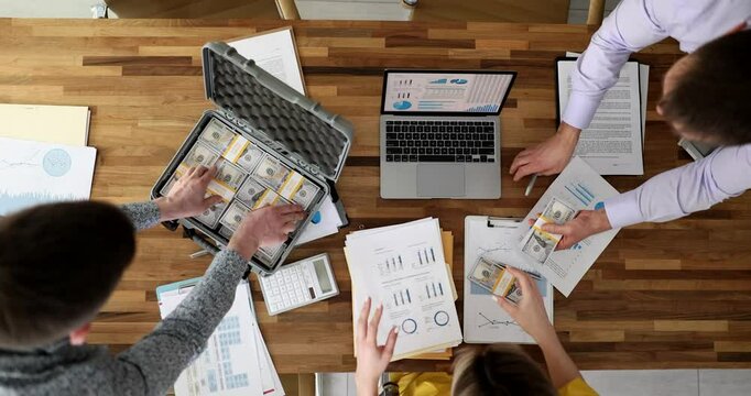 Successful rich seo handing out cash dollars to business team. Profitable financial transaction and cash investment