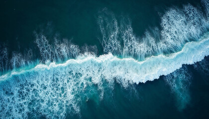 Aerial view of deep blue ocean waves with white foam, showcasing natural beauty and vastness.






