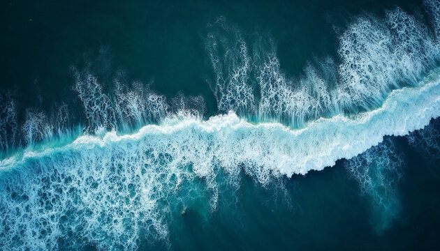 Aerial view of deep blue ocean waves with white foam, showcasing natural beauty and vastness.






