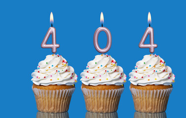 Birthday Cupcakes With Candles Lit Forming The Number 404