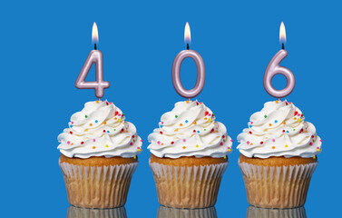 Birthday Cupcakes With Candles Lit Forming The Number 406