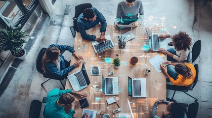 Diverse Team Collaborating at a Table with Laptops and Digital Interface Overlays