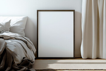 Empty wooden frame leaning against a wall next to a cozy bed with soft linens and curtains. Minimalist bedroom interior with natural light and shadows for art display and print