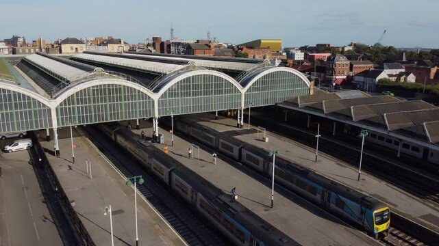 Drone. UK northern train service. Train on tracks.