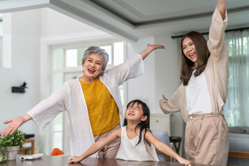 Three generation asian family together at home, happy grandmother, mother and daughter bonding, standing by window arch, family love and connection, lifestyle of asian family with different ages